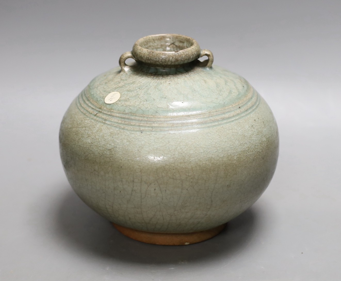 A Thai Sawankhalok green glazed ring handled jar, 15th century